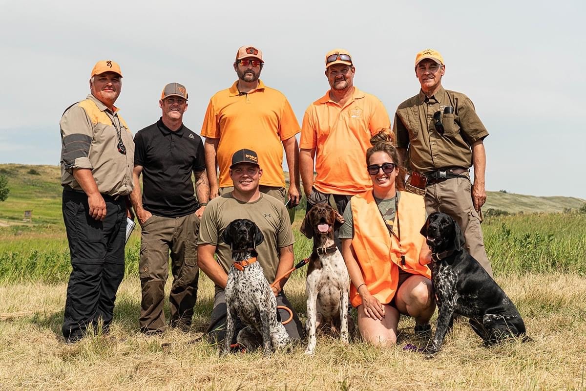 NAVHDA participants and hunting dogs gathered outdoors
