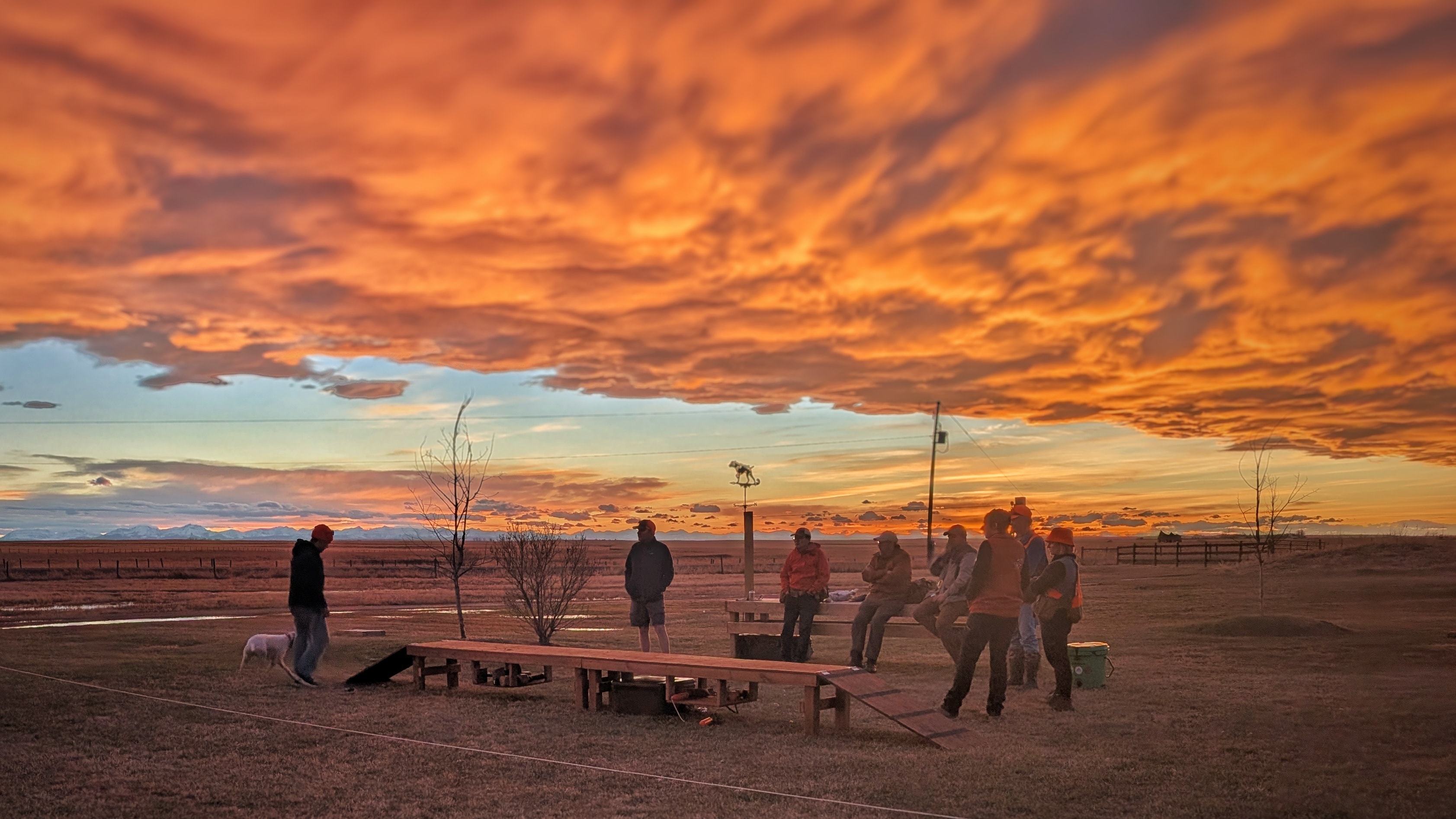 Westrock Kennels community gathering outdoors beneath a dramatic prairie sunset